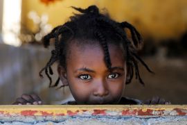 An Ethiopian girl stands at the window of a temporary shelter, at the Village 8 refugees transit camp, which houses Ethiopian refugees fleeing the fighting in the Tigray region, near the Sudan-Ethiopia border, Sudan, December 2, 2020. REUTERS/Baz Ratner TPX IMAGES OF THE DAY
