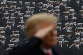 U.S. Navy cadets wearing protective masks salute as U.S. President Trump stands onto the field at Michie Stadium ahead of the annual Army-Navy collegiate football game, in West Point, New York, U.S., December 12, 2020. REUTERS/Tom Brenner