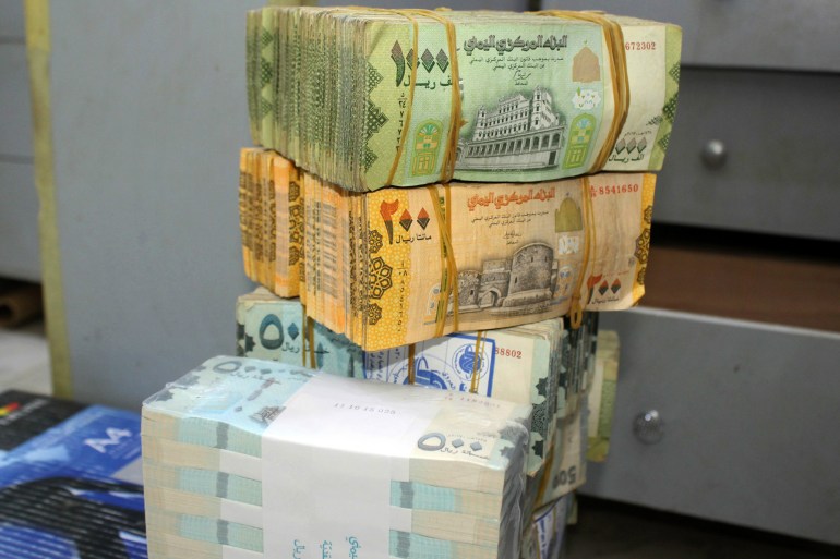 Old and new Yemeni bank notes are pictured at a money exchange office in the southern port city of Aden on January 23, 2020. - A flare-up in a local currency war has sent the Yemeni rial crashing, aggravating a humanitarian crisis that has driven millions to the brink of famine. The trigger: a ban imposed by the Iran-aligned Huthi rebels, who control the capital Sanaa and most of the country's north, on using new banknotes printed by the central bank in Aden. The southern port city became the seat of the internationally recognised government after it was driven out of Sanaa in 2014. (Photo by Saleh Al-OBEIDI / AFP) (Photo by SALEH AL-OBEIDI/AFP via Getty Images)