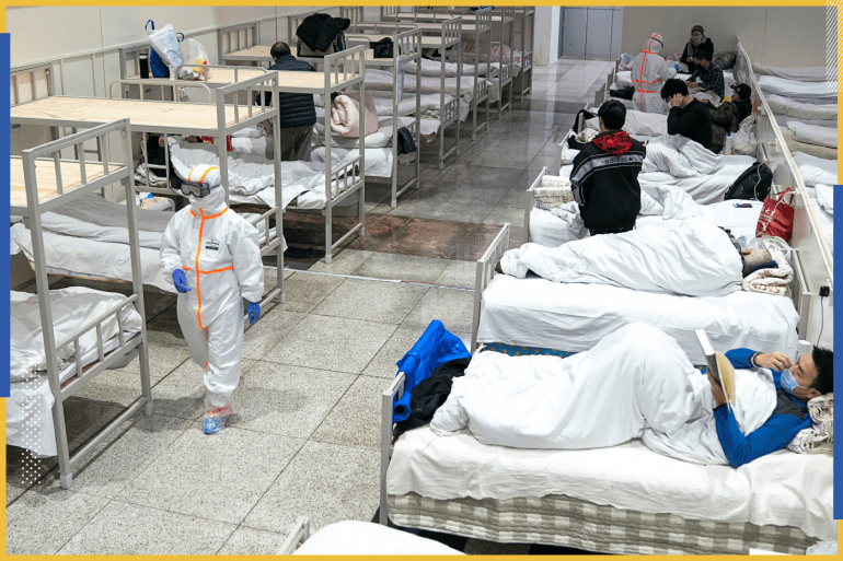 Medical workers in protective suits attend to patients at the Wuhan International Conference and Exhibition Center, which has been converted into a makeshift hospital to receive patients with mild symptoms caused by the novel coronavirus, in Wuhan, Hubei province, China February 5, 2020. Picture taken February 5, 2020. China Daily via REUTERS ATTENTION EDITORS - THIS IMAGE WAS PROVIDED BY A THIRD PARTY. CHINA OUT.