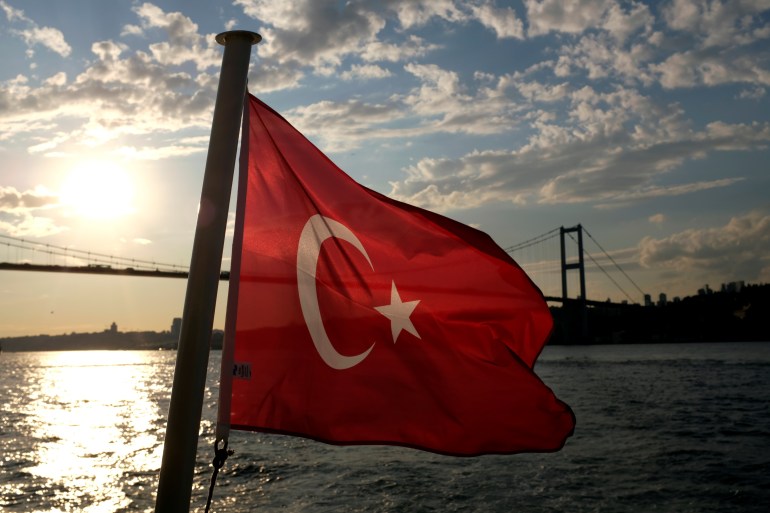 A Turkish flag with the Bosphorus Bridge in the background, flies on a passenger ferry in Istanbul, Turkey September 30, 2020. REUTERS/Murad Sezer