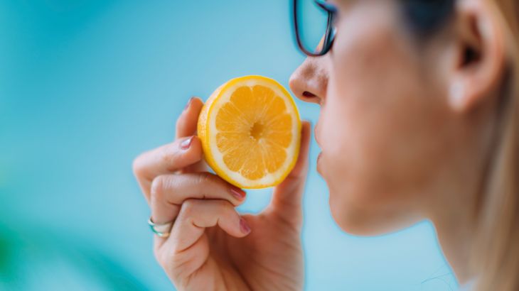 Loss of smell. Woman not able to smell the scent of a lemon. Loss of smell is a possible symptom of Covid-19, the disease caused by the new coronavirus SARS-CoV-2.