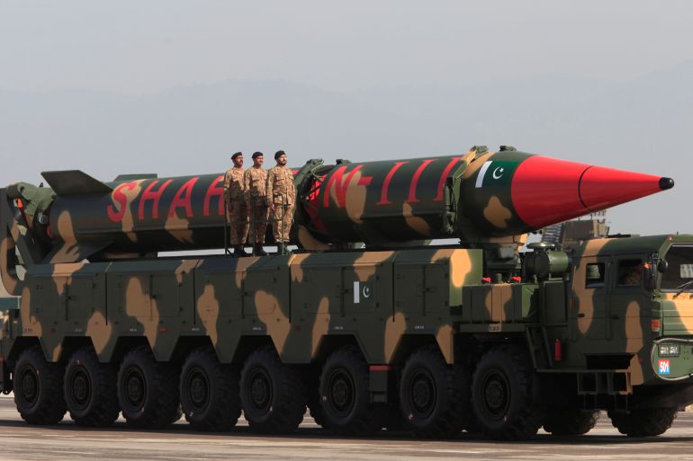 Pakistani military personnel stand beside a Shaheen III surface-to-surface ballistic missile during Pakistan Day military parade in Islamabad