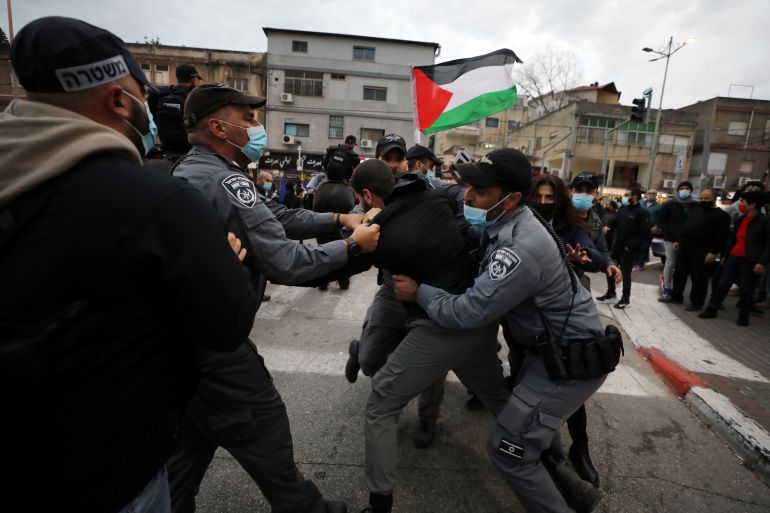 Israeli police detain a protester during a demonstration against Israeli Prime Minister Benjamin Netanyahu as he visits Nazareth, an Israeli-Arab city, ahead of Israel's upcoming election