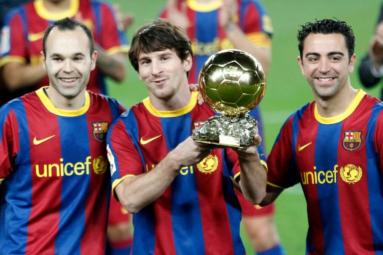 Barcelona's Lionel Messi poses with his Ballon d'Or trophy next to his teammates Iniesta and Hernandez before their Spanish King's Cup soccer match against Real Betis in Barcelona