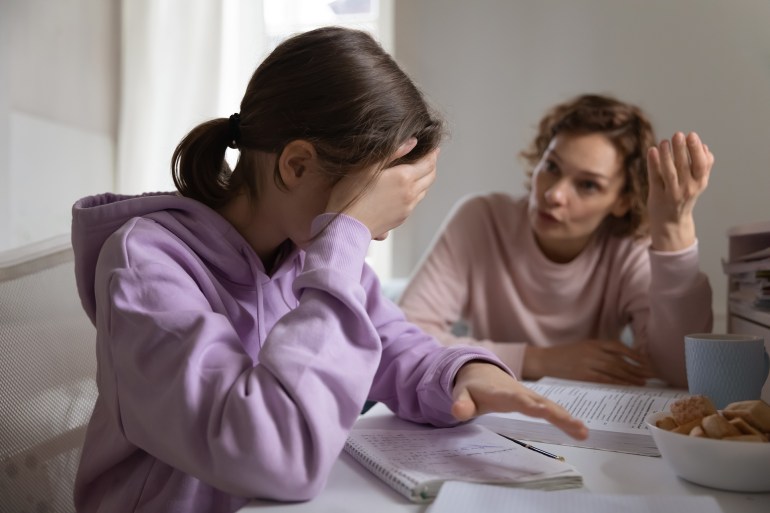 Angry adult mother scolding lazy teen daughter for bad school results at home. Frustrated mum talking to upset teenage girl arguing disciplining child must study. Parent and children conflicts concept; Shutterstock ID 1701862429; Department: -