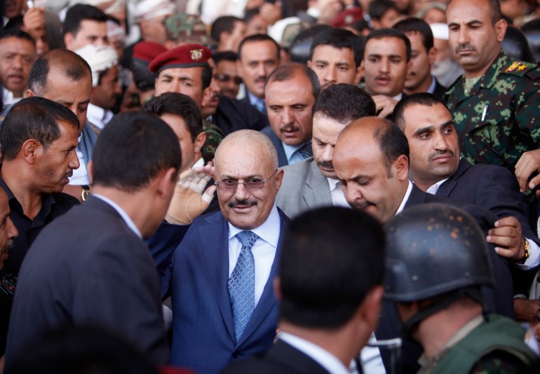 Yemen's former President Ali Abdullah Saleh gestures as he arrives to a rally in Sanaa