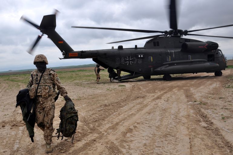 A soldier of the German armed forces Bundeswehr leaves a CH-53 helicopter in Kunduz