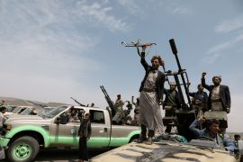 Houthi fighters shout slogans during a gathering of Houthi loyalists on the outskirts of Sanaa
