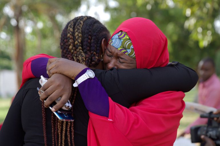 Members of the #BringBackOurGirls campaign embrace each other at a sit-out in Abuja, Nigeria