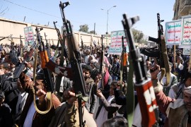 Houthi supporters hold up their weapons during a demonstration against the United States decision to designate the Houthis as a foreign terrorist organisation, in Sanaa