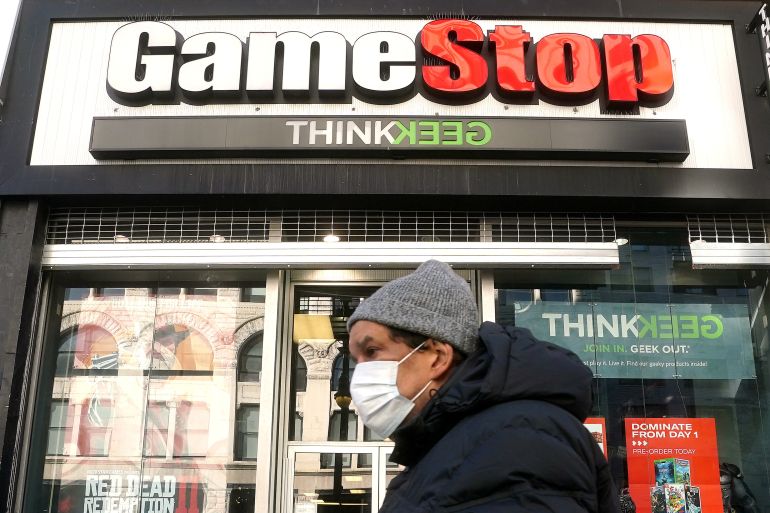 A person walks past a GameStop in New York