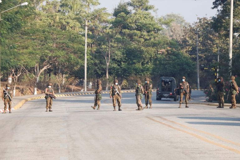 Soldiers stand guard at a Myanmar's military checkpoint on the way to the congress compound in Naypyitaw