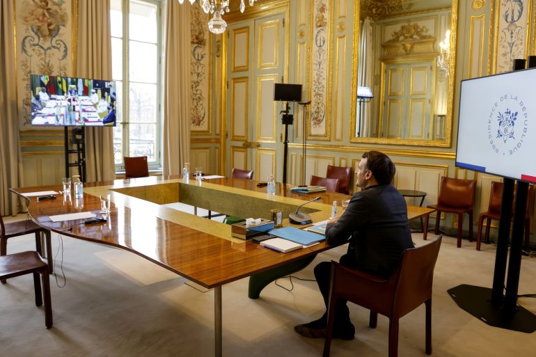 French President Emmanuel Macron looks on during a meeting via videoconference with leaders of the G5 Sahel as they attend a two-day summit in N'Djamena, at the Elysee Presidential Palace in Paris, France February 15, 2021. Ludovic Marin/Pool via REUTERS
