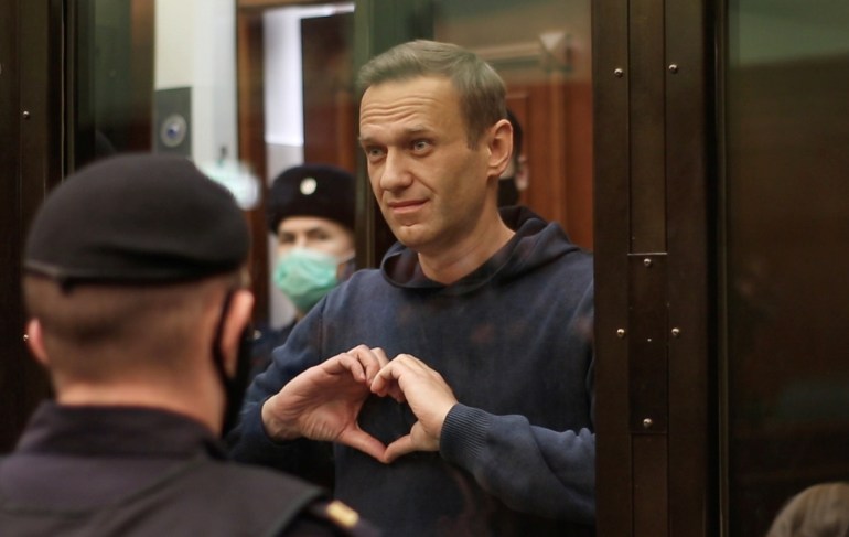 A still image taken from video footage shows Russian opposition leader Alexei Navalny, who is accused of flouting the terms of a suspended sentence for embezzlement, making a hand heart gesture during the announcement of a court verdict in Moscow, Russia February 2, 2021. Press Service of Simonovsky District Court/Handout via REUTERS ATTENTION EDITORS - THIS IMAGE HAS BEEN SUPPLIED BY A THIRD PARTY. NO RESALES. NO ARCHIVES. MANDATORY CREDIT.