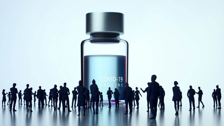 Digital generated image of huge COVID-19 vaccine bottle standing surrounded by people against white background.