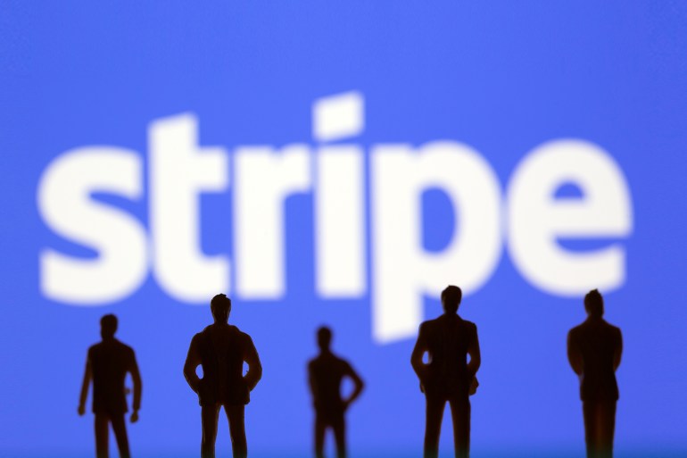 Small toy figures are seen in front of Stripe logo in this illustration picture taken March 15, 2021. REUTERS/Dado Ruvic/Illustration