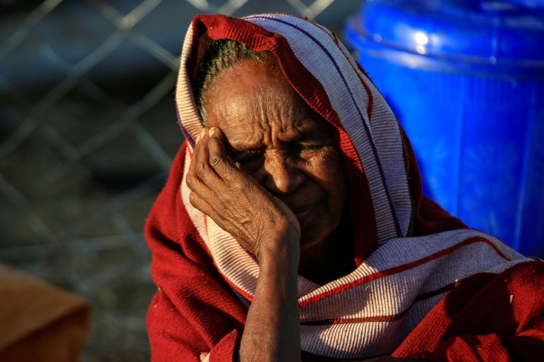 FILE PHOTO: An Ethiopian woman, who fled the ongoing fighting in Tigray region, is seen at dawn within Hamdayet village on the Sudan-Ethiopia border, in the eastern Kassala state, Sudan December 16, 2020. REUTERS/Mohamed Nureldin Abdallah/File Photo