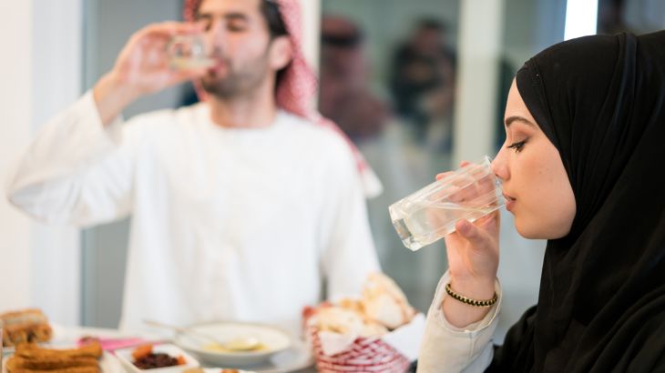 Muslim family drinking water for breaking Ramadan fasting