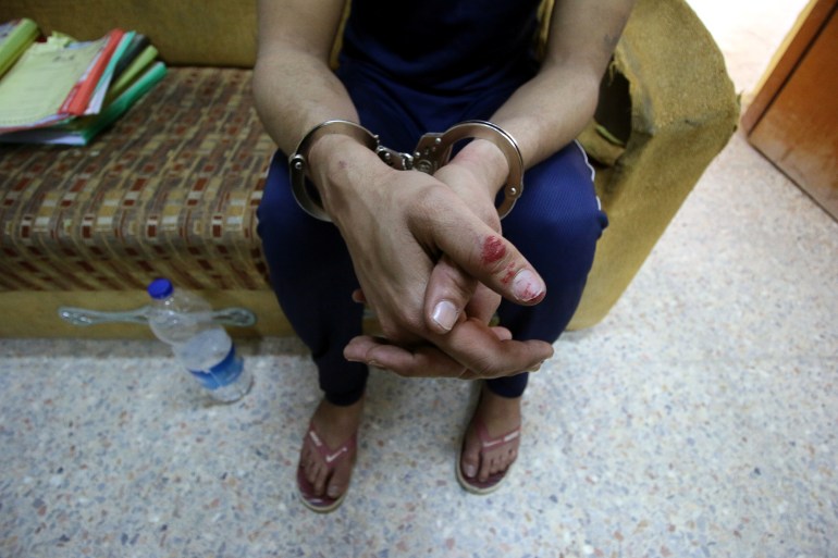 An Iraqi suspect who was arrested for drug-related crimes is seen at a police station in Basra