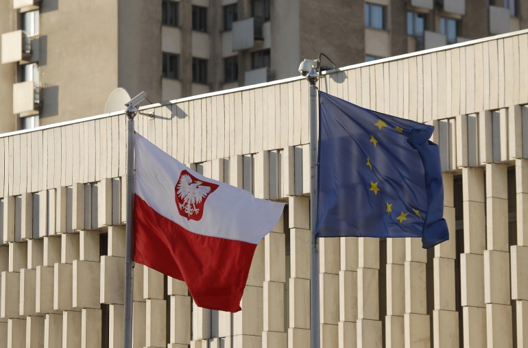 Flags of Poland and European Union fly outside the Polish embassy in Moscow
