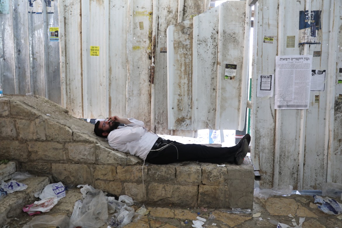 One of the extremist Jews lies at the site where the victims fell during the stampede (European)