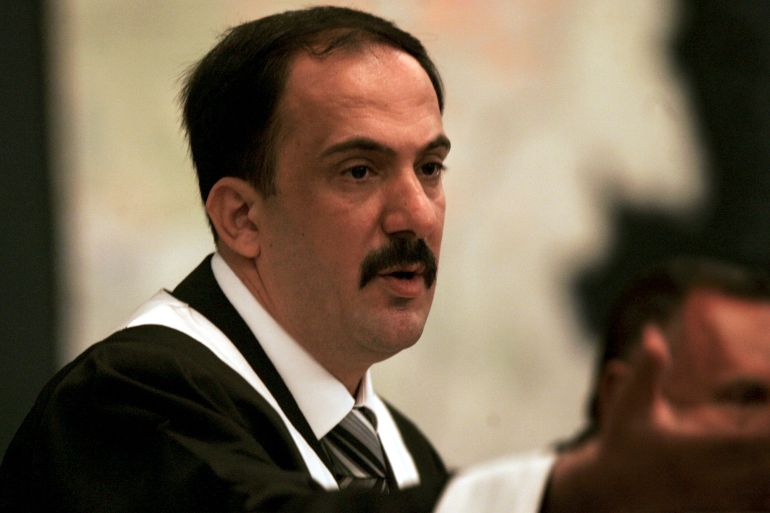 Chief Judge Mohammed Oraibi Al-Khalifa asks one of the defendants to leave the room during the Anfal trial verdict session in Baghdad June 24, 2007. An Iraqi court on Sunday sentenced to death two former military commanders under Saddam Hussein for their role in a genocidal campaign against Iraq's ethnic Kurds that killed tens of thousands in the 1980s. Two other commanders were sentenced to life in prison, while charges were dropped against the former governor of Mosul province for lack of evidence. REUTERS/Joseph Eid/Pool (IRAQ)