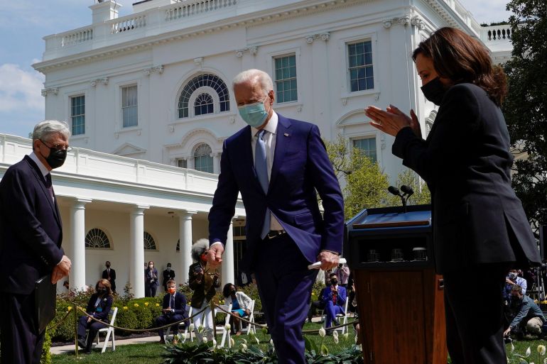 U.S. Attorney General Merrick Garland watches as Vice President Kamala Harris applauds President Joe Biden after Biden announced his administration's first steps to curb gun violence in the Rose Garden at the White House in Washington, U.S., April 8, 2021. REUTERS/Kevin Lamarque