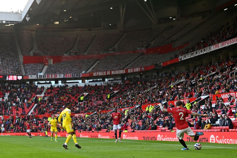 Manchester United v Fulham - Premier League MANCHESTER, ENGLAND - MAY 18: A general view of play as fans watch on during the Premier League match between Manchester United and Fulham at Old Trafford on May 18, 2021 in Manchester, England. A limited number of fans will be allowed into Premier League stadiums as Coronavirus restrictions begin to ease in the UK following the COVID-19 pandemic. (Photo by Paul Ellis - Pool/Getty Images)