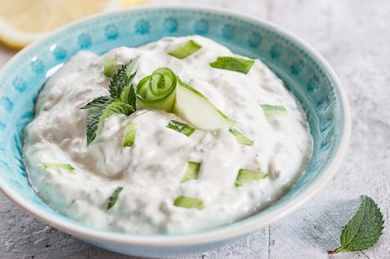 Zaziki (greek yoghurt with cucumber and garlic), lemon slices & mint leaves, studio