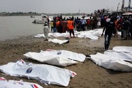 epa09175111 Local people stand by the river as they look at rescue workers lay out the bodies recovered from the river in body bags after a speedboat collided with another boat in the Padma River in Madaripur District, Bangladesh, 03 May 2021. Local police said at least 26 people were killed and several others went missing after the incident. EPA-EFE/STR