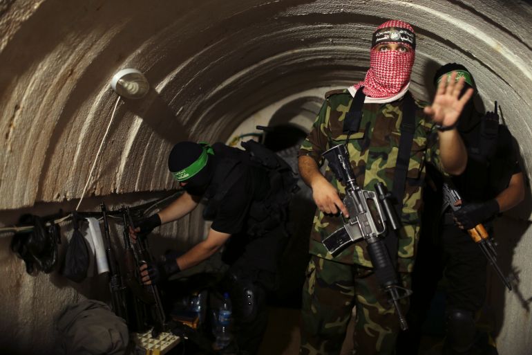 A Palestinian fighter from the Izz el-Deen al-Qassam Brigades, the armed wing of the Hamas movement, gestures inside an underground tunnel in Gaza