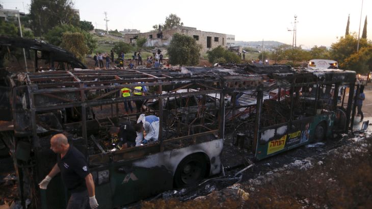Israeli police forensic experts work at the scene after an explosion tore through a bus in Jerusalem