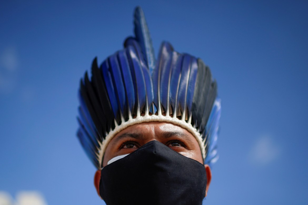 An indigenous person takes part in the protest demonstrations near Congress headquarters in Brasilia, as the Senate investigates the government's response to the pandemic (Reuters)