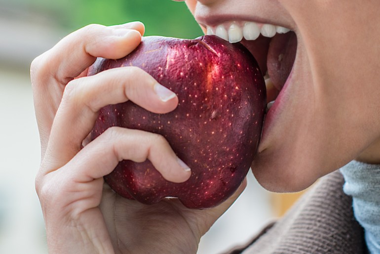 girl eats an apple