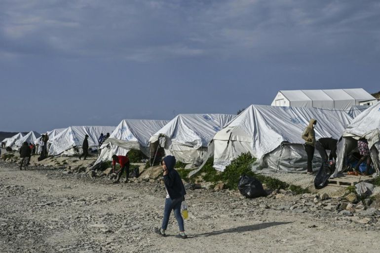 A child walks past tents inside the new refugee camp of Kara Tepe in Mytilene, on Lesbos, on March 29, 2021. EU home affairs commissioner Ylva Johansson pledged 276 million euros ($326 million) of EU money for new camps on the islands of Lesbos, Chios, Samos, Kos and Leros, where nearly 14,000 migrants are hosted, during a visit to the island of Lesbos, which hosts more than 8,000 asylum seekers. She said it was imperative to find "new political solutions" to share the burden between EU states. ARIS MESSINIS / AFP