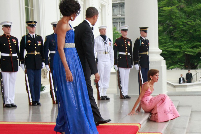 President Barack Obama and first lady Michelle Obama look on as the author falls on the White House stairs before the arrival of Mexican President Felipe Calderon and his wife Margarita Zavala in May 2010. | AP Photo/Charles Dharapak