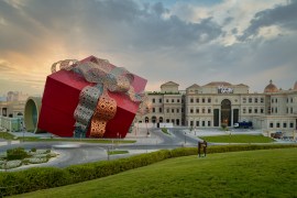 Doha , Qatar-July 2,2020:Luxurious shopping mall in Katara cultural village in Doha Qatar exterior sunset shot showing the entrance with people and cars in the street; Shutterstock ID 1773390755; purchase_order: Daily News; job: AJnet; client: Juneteenth; other