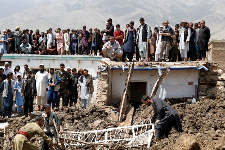 People search for victims after floods in Charikar, capital of Parwan province