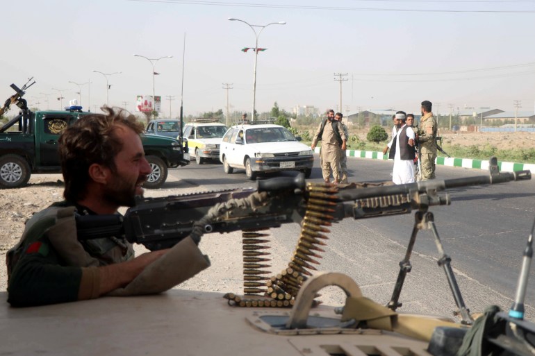 Afghan security forces keep watch at checkpoint in Guzara district of Herat province