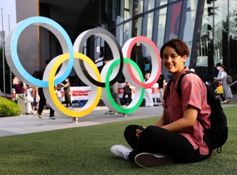 Tsubata, nurse and boxer, poses in front of the Olympic Rings in Tokyo