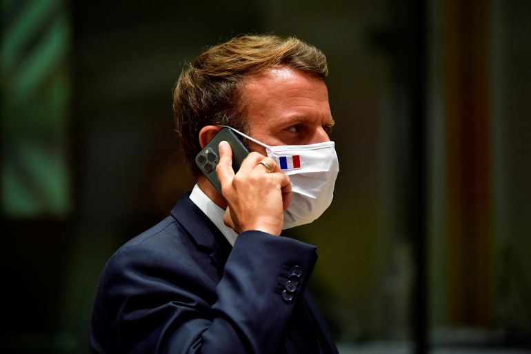 France's President Emmanuel Macron talks on the phone during the first face-to-face EU summit since the coronavirus disease (COVID-19) outbreak, in Brussels, Belgium July 20, 2020. John Thys/Pool via REUTERS