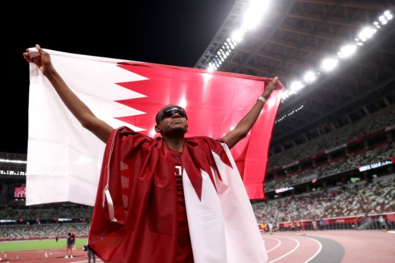 Athletics - Olympics: Day 9 TOKYO, JAPAN - AUGUST 01: Gold medalist Mutaz Essa Barshim of Team Qatar celebrates on the track following the Men's High Jump Final on day nine of the Tokyo 2020 Olympic Games at Olympic Stadium on August 01, 2021 in Tokyo, Japan. (Photo by Cameron Spencer/Getty Images)