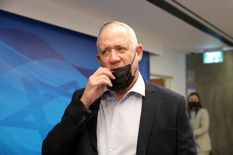 Israeli Defense Minister Benny Gantz adjusts his mask during the weekly cabinet meeting at the prime minister's office in Jerusalem August 1, 2021. Abir Sultan/Pool via REUTERS