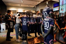 Fans buy Paris St Germain Messi football jerseys in Paris