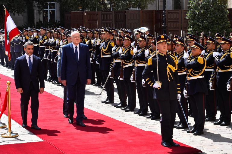 Lebanon's new Prime Minister Najib Mikati reviews an honor guard during an official ceremony at the Government Palace in Beirut
