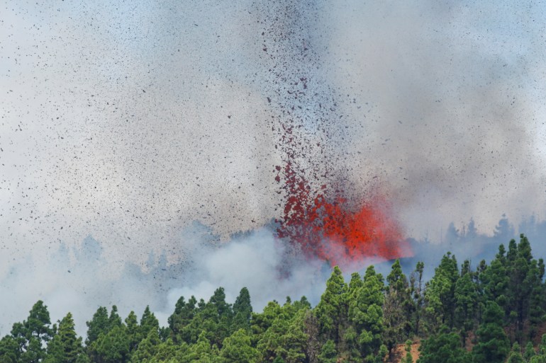 Lava and smoke are seen following the eruption of a volcano in Spain