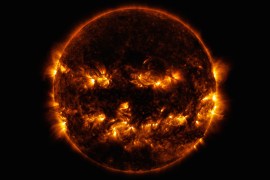 Active regions on the sun combined to look something like a jack-o-lantern’s face on Oct. 8, 2014. The image was captured by NASA's Solar Dynamics Observatory, or SDO, which watches the sun at all times from its orbit in space. The active regions in this image appear brighter because those are areas that emit more light and energy. They are markers of an intense and complex set of magnetic fields hovering in the sun’s atmosphere, the corona. This image blends together two sets of extreme ultraviolet wavelengths at 171 and 193 Ångströms, typically colorized in gold and yellow, to create a particularly Halloween-like appearance. Credit: NASA/SDO