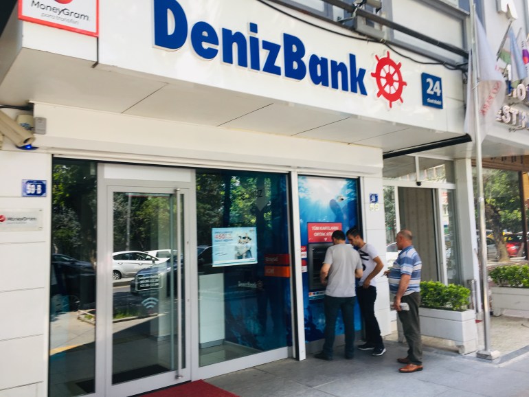 مواطن تركي يجري معاملة مالية قي الصراف الآلي التابع لبنك دينيز