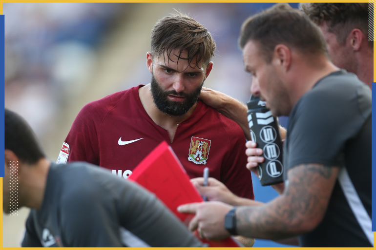 COLCHESTER, ENGLAND - AUGUST 24: Jordan Turnbull is shown tactics by goalkeeper coach Dan Watson during the Sky Bet League Two match between Colchester United and Northampton Town at JobServe Community Stadium on August 24, 2019 in Colchester, England. (Photo by Pete Norton/Getty Images)